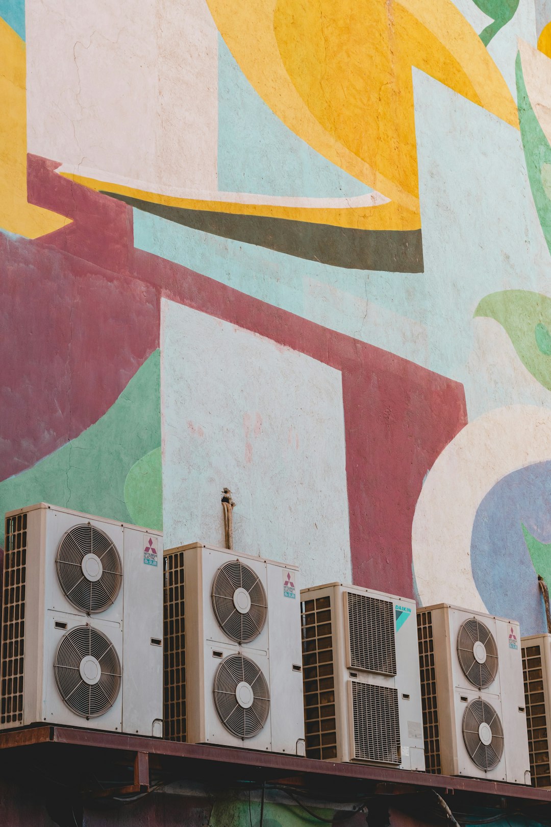 Patterns of the wall of the Bahman cinema and a row of split air conditioners.